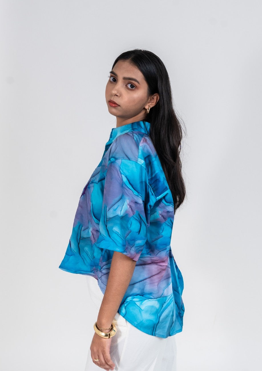 Cropped women's shirt in bright blue and purple marble print with short sleeves and thread work embroidery