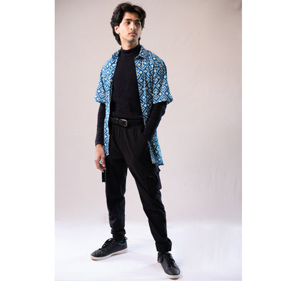 Blue with white and yellow motifs button down short sleeved shirt