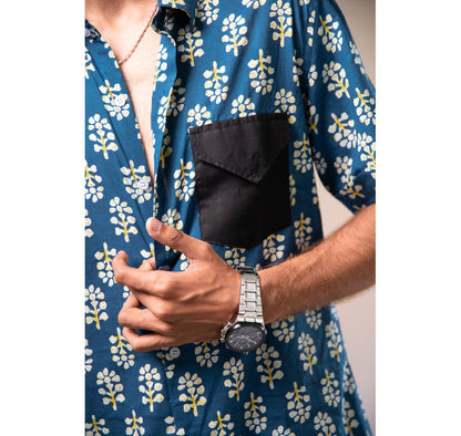 Blue with white and yellow motifs button down short sleeved shirt