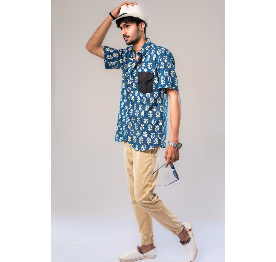 Blue with white and yellow motifs button down short sleeved shirt