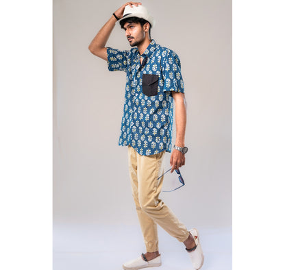 Blue with white and yellow motifs button down short sleeved shirt