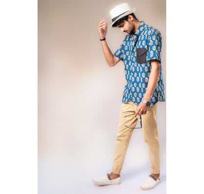 Blue with white and yellow motifs button down short sleeved shirt
