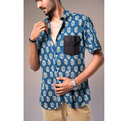Blue with white and yellow motifs button down short sleeved shirt