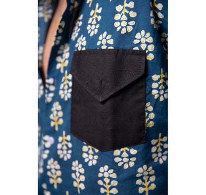 Blue with white and yellow motifs button down short sleeved shirt