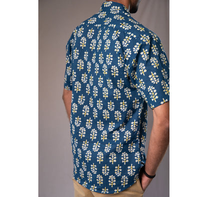 Blue with white and yellow motifs button down short sleeved shirt