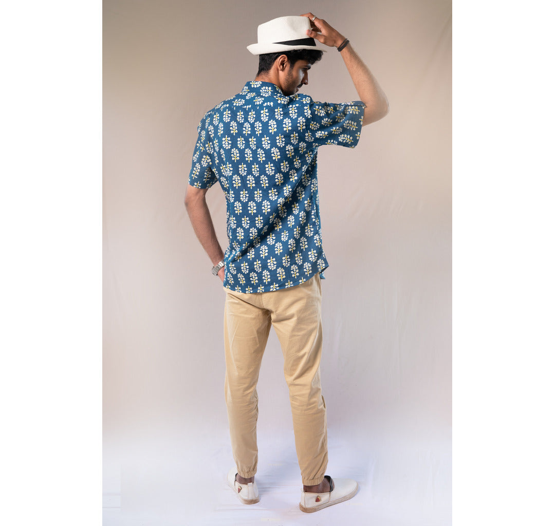 Blue with white and yellow motifs button down short sleeved shirt