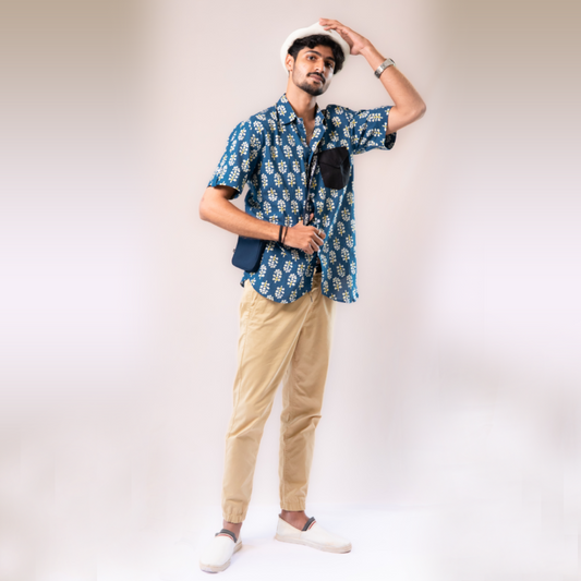 Blue with white and yellow motifs button down short sleeved shirt